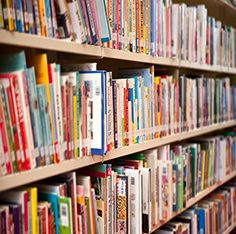 Shelves full of books representing the 7,000+ book library