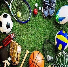 Sports equipment including footballs, rackets and a volleyball